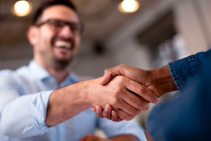 dental patient shaking hands with doctor