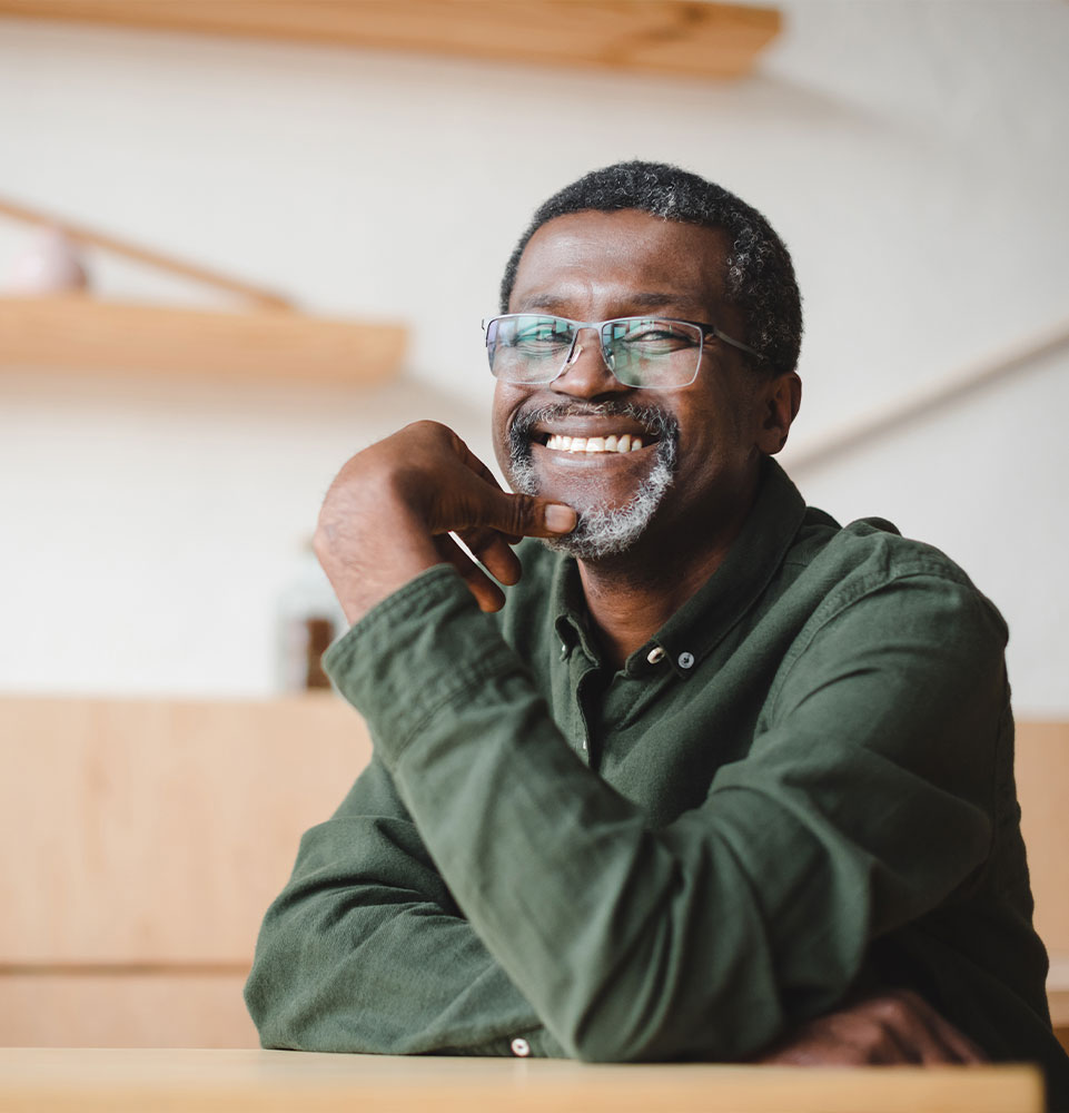 happy mature man in cafe smiling brightly