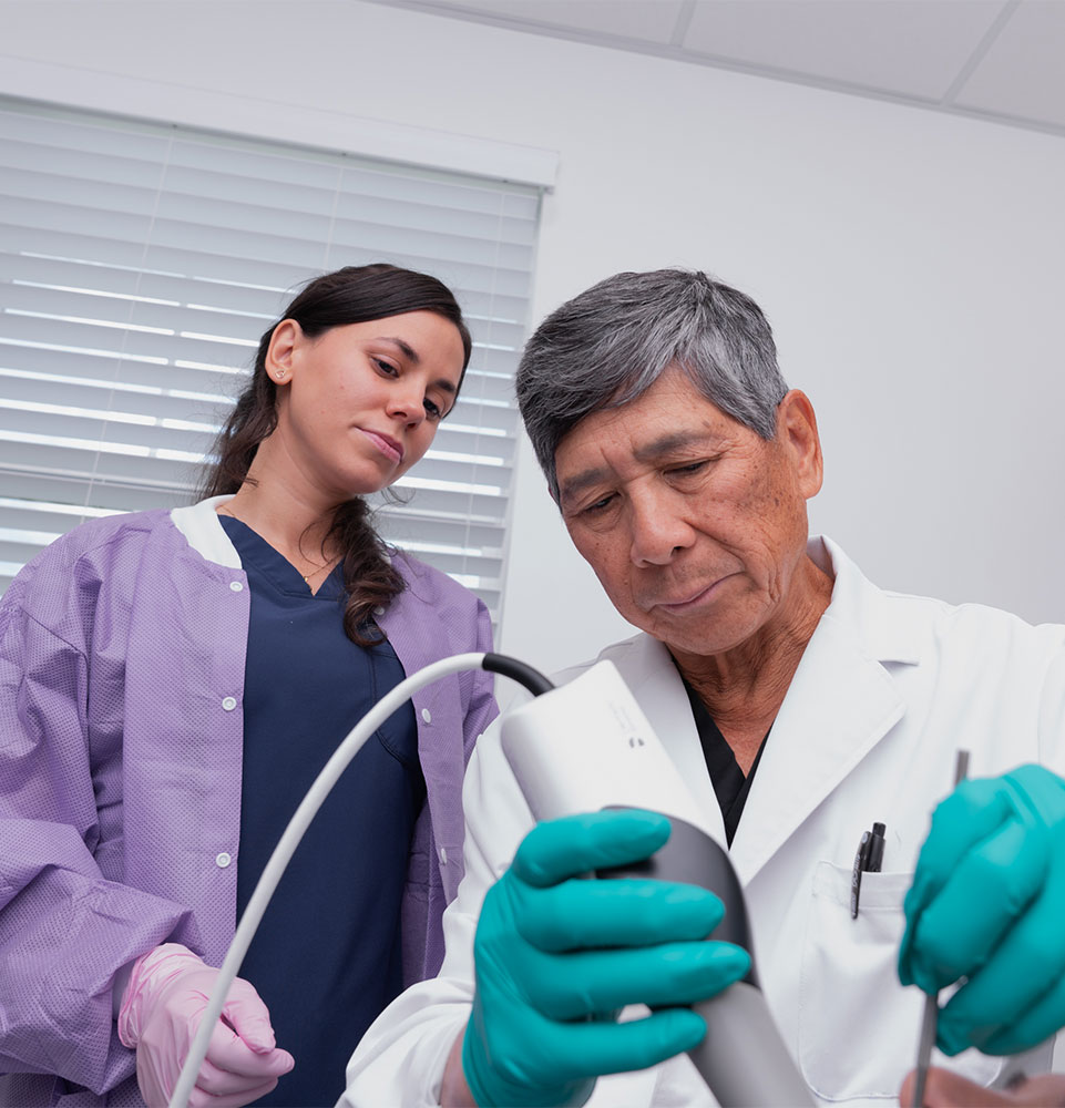 doctor and staff member helping with dental procedure