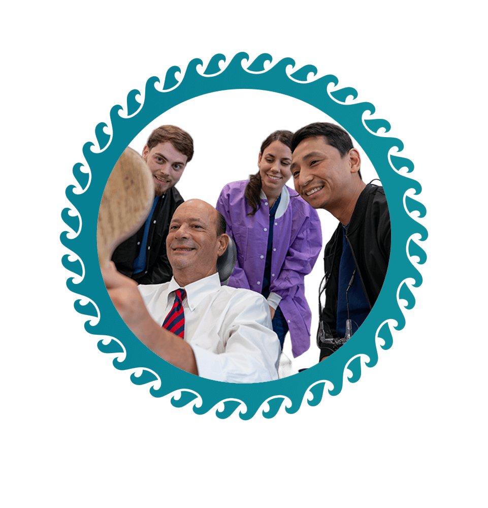 team members and patient smiling after patient's dental procedure