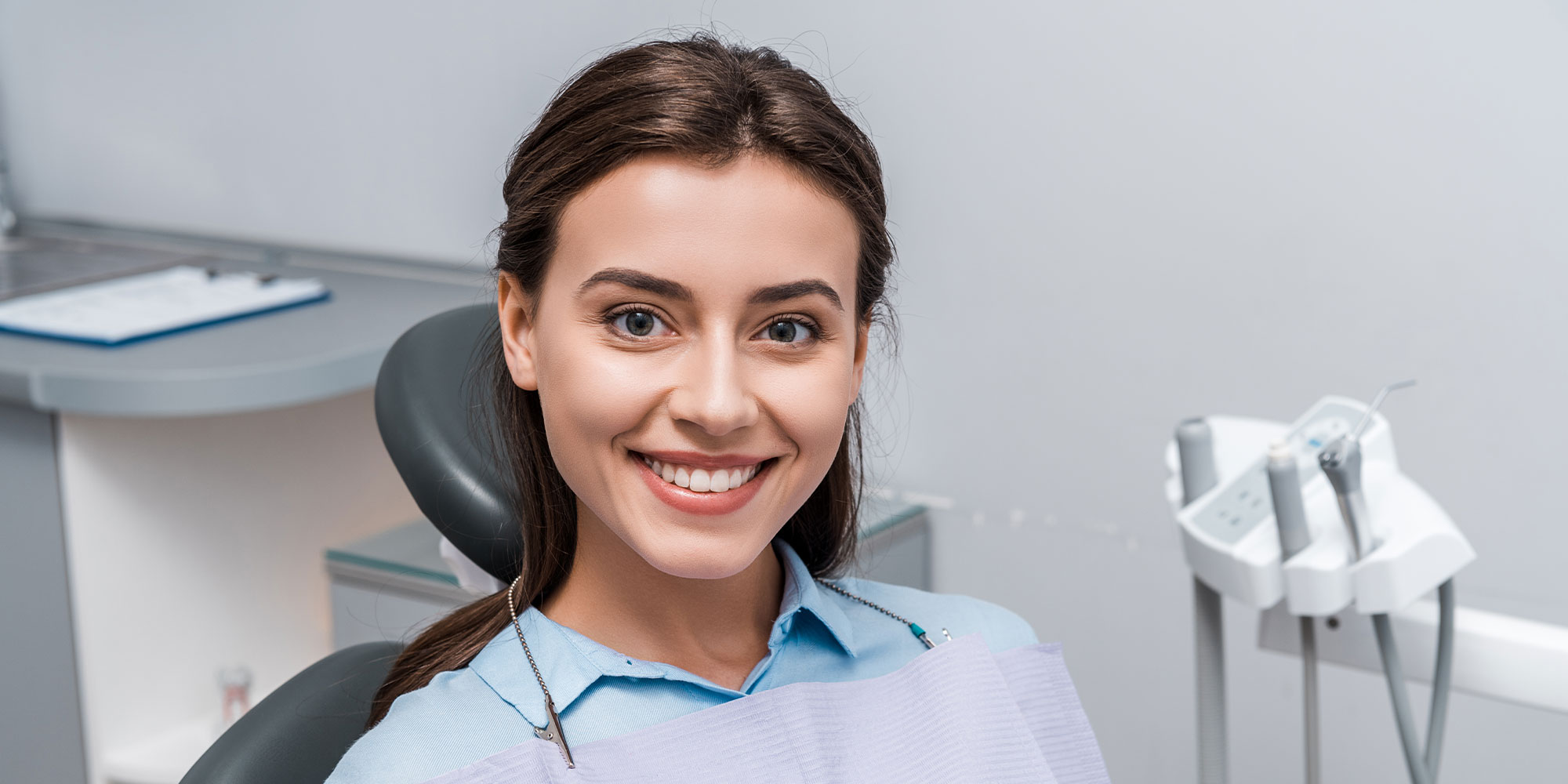 beautiful woman sitting and smiling in dental clinic