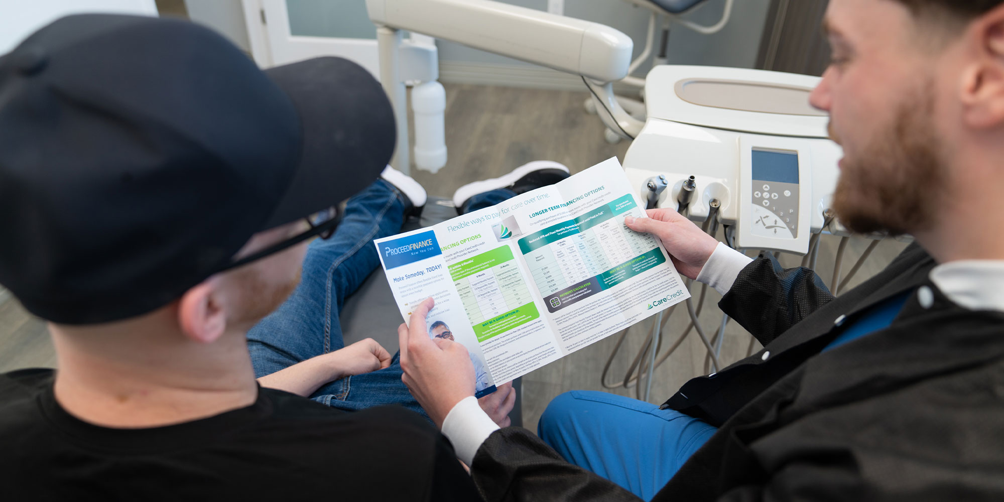 staff member going over dental finance infirmation with patient within the dental center