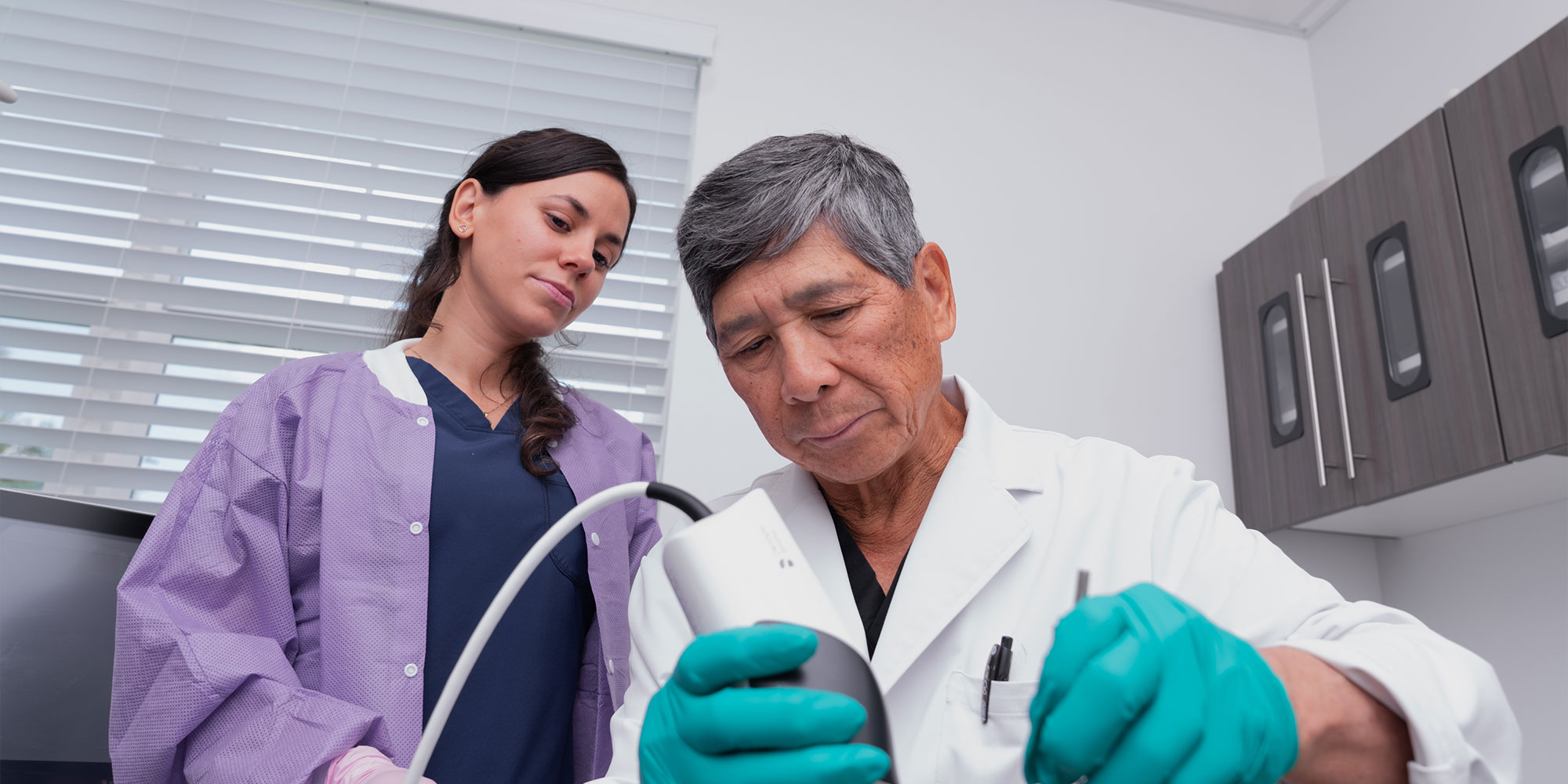 doctor and staff member helping with dental procedure