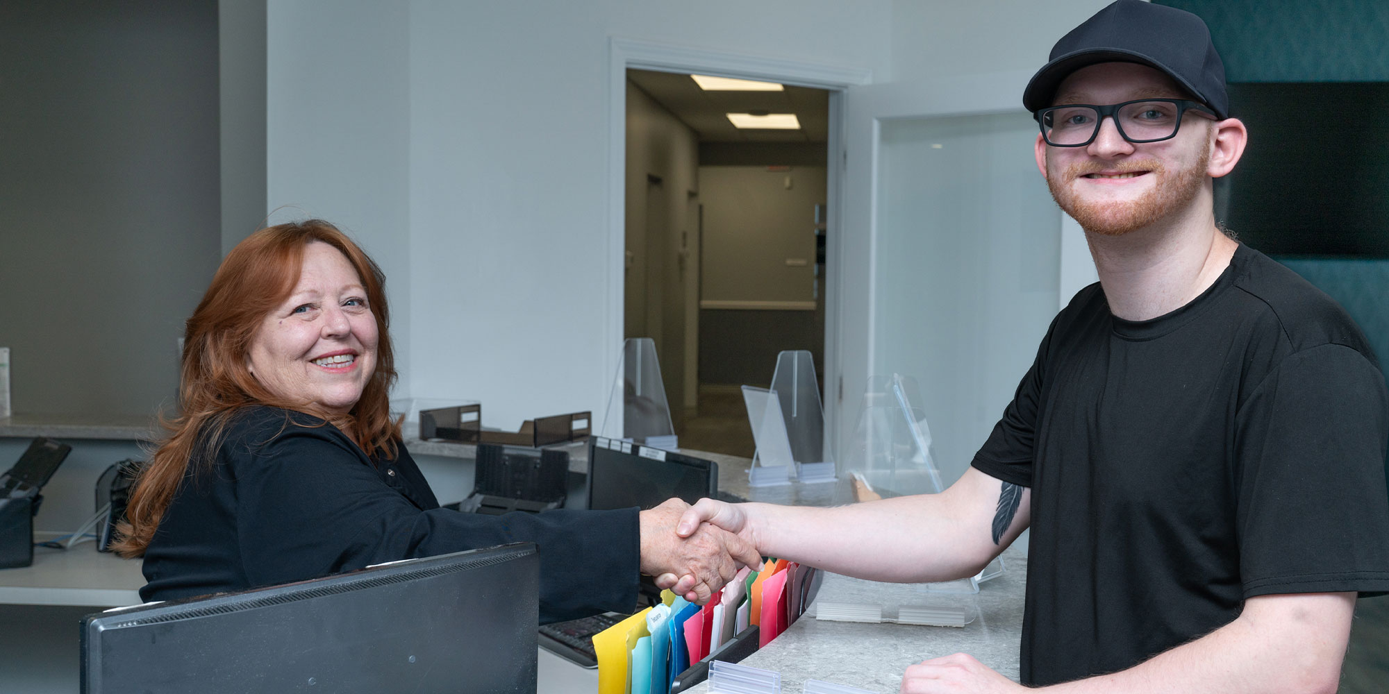 patient being helped at the front desk of the dental center ready for treatment
