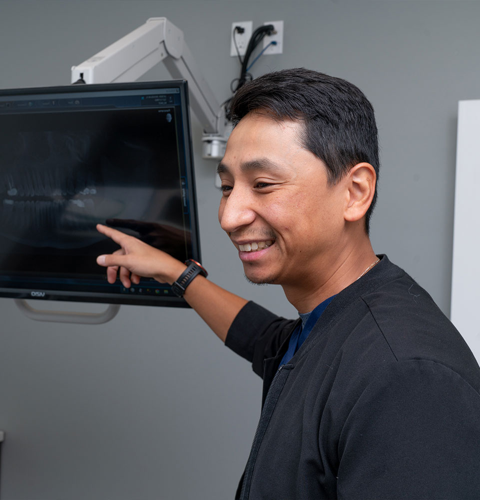 doctor going over dental procedure information with patient
