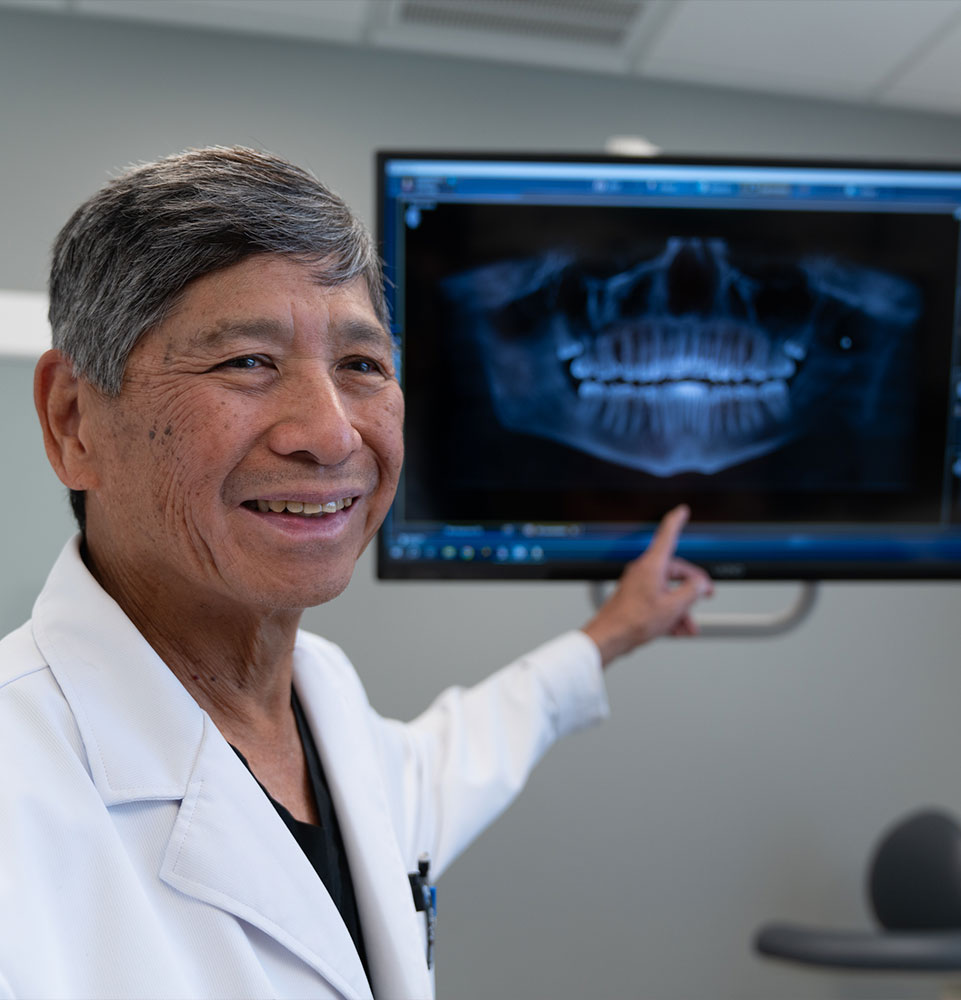 doctor going over dental procedure information with patient within the dental center