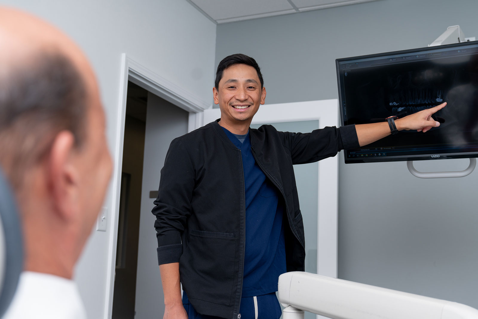 doctor going over dental procedure information with patient within the dental center