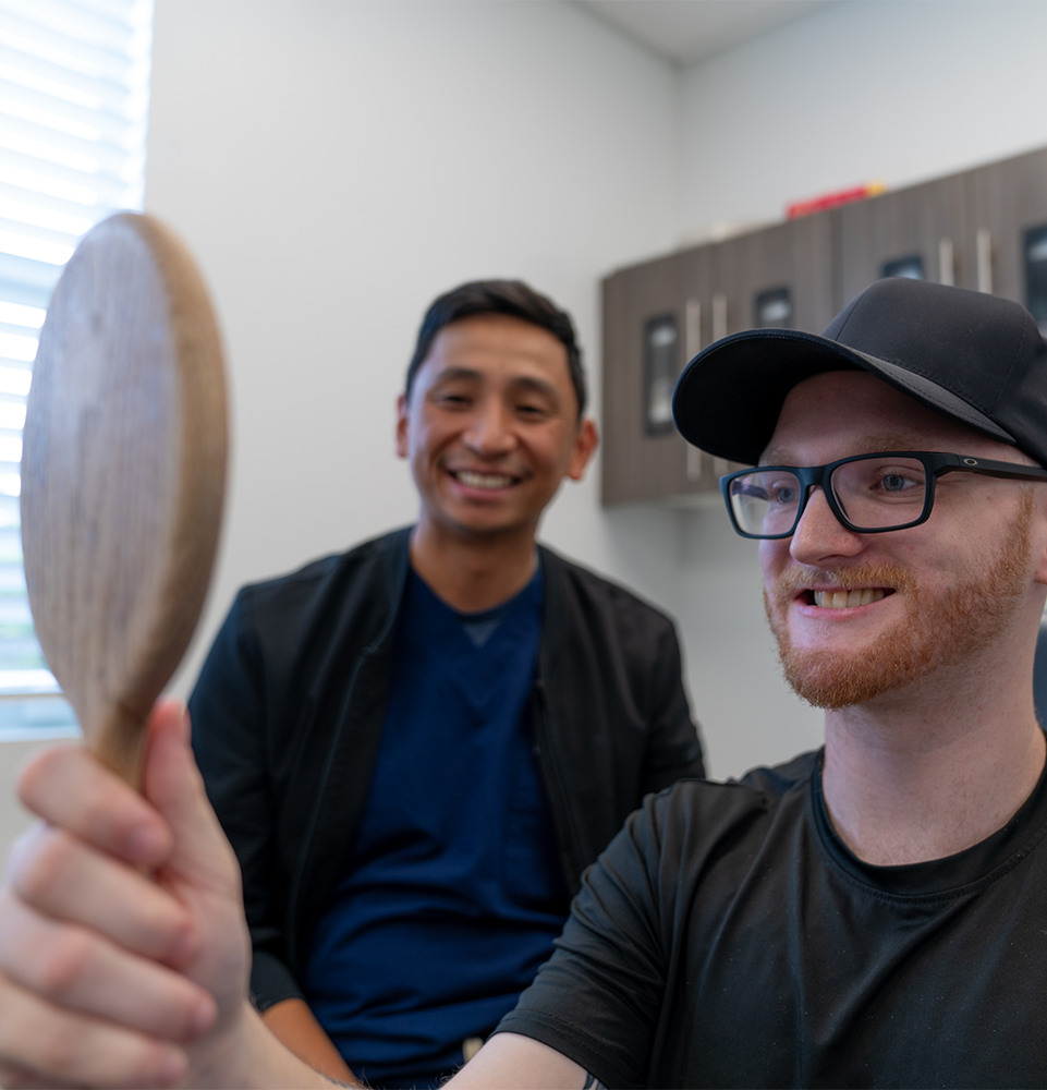 patient smiling brightly after their dental treatment within the dental center with doctor