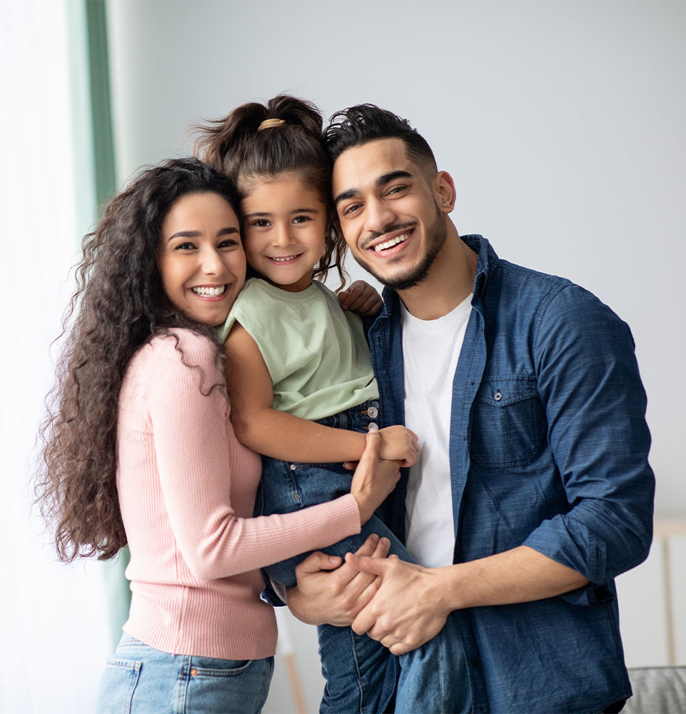 Portraif Of Happy Arabic Parents Posing With Their Little Daughter At Home