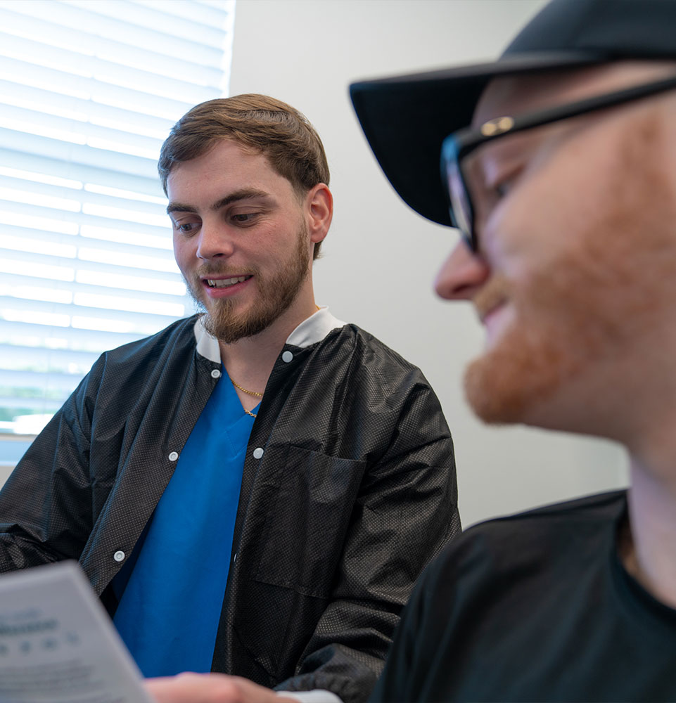 staff member showing patient dental finance plans for their dental procedure treatment