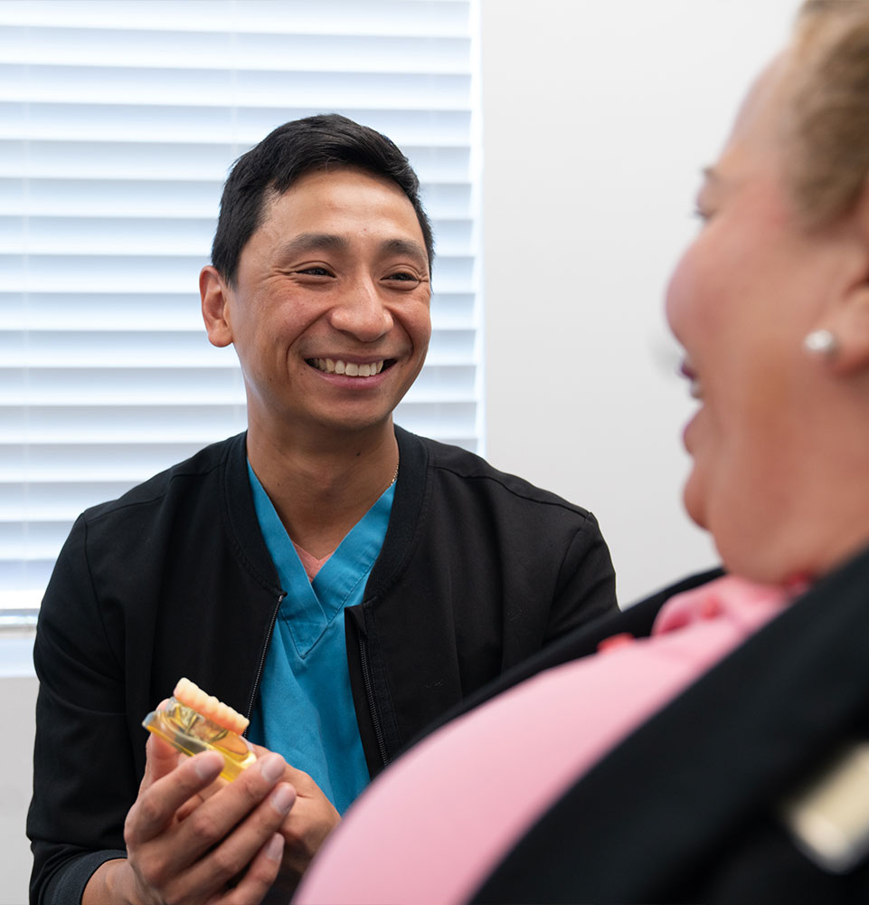 doctor going over dental procedrue information with patient within the dental center