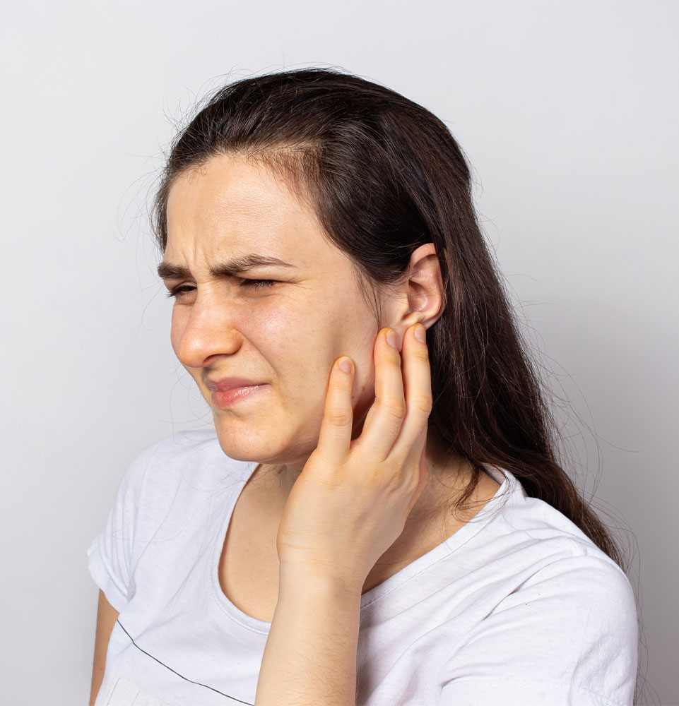 young female experiencing mouth pain in the jaw area