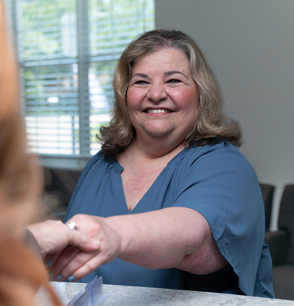 patient being helped at the front desk of the dental center