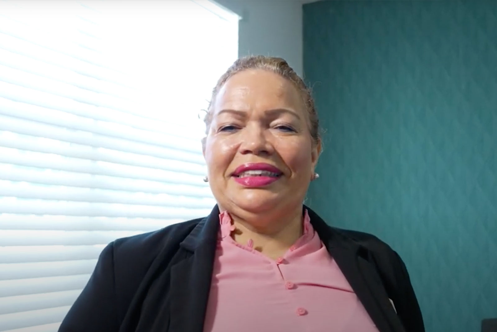 headshot of patient smiling brightly after their dental procedure within the dental center
