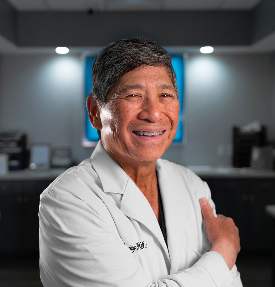 headshot of doctor smiling within the dental center