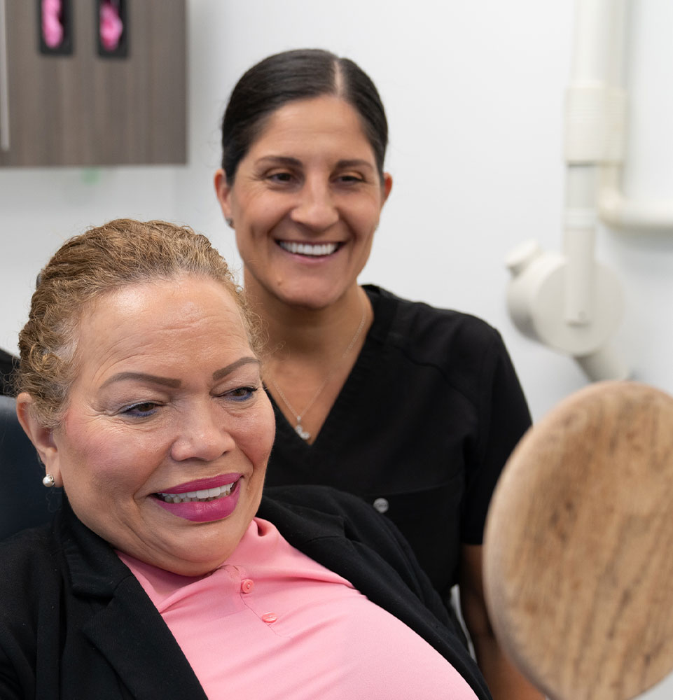 Patient looking into Mirror smiling